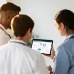 physician reviewing lab results with a patient during a jorie weight loss consultation, bright modern clinic, neutral tones